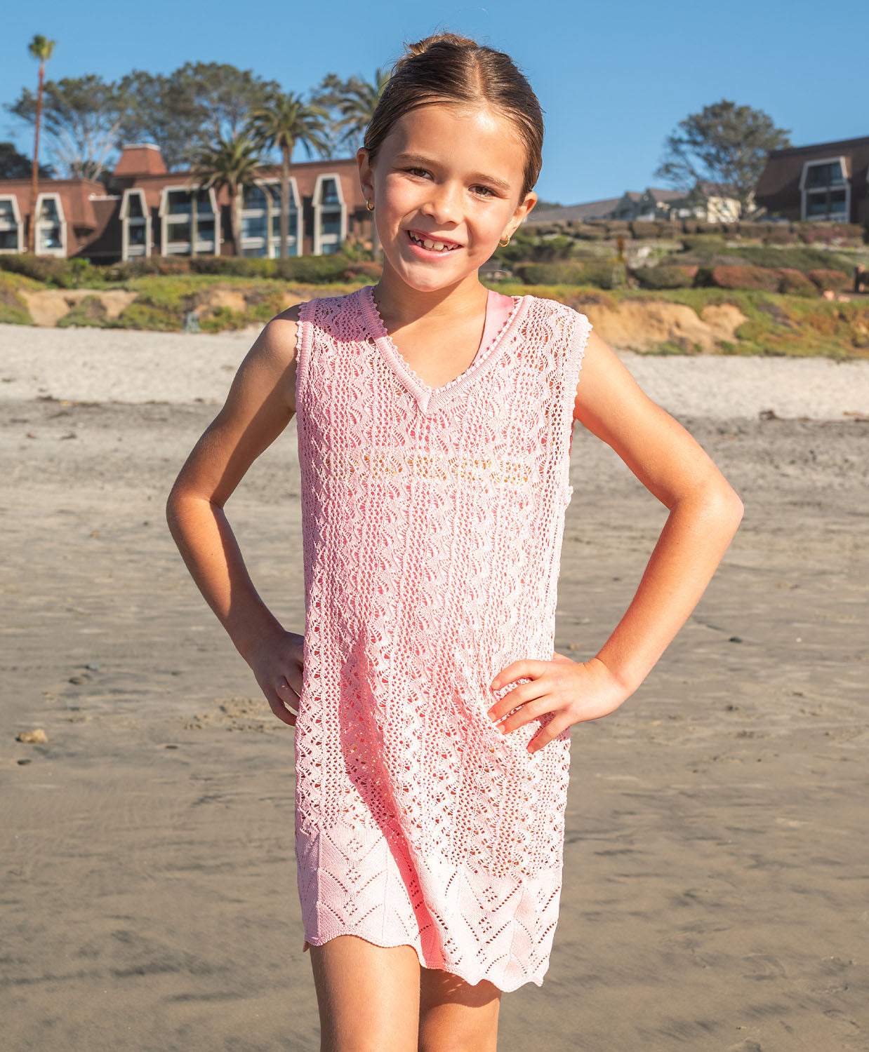 Kids Pink Sands Kaia Knit Dress – soft pink crochet cover-up with playful knit details and relaxed V-neckline.
