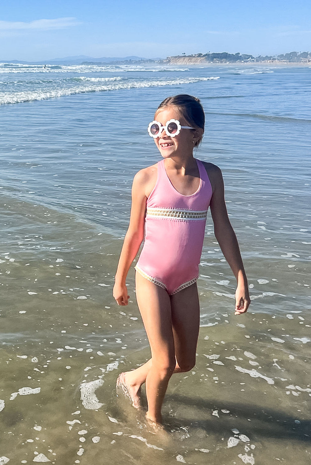 Kids Pink Sands Mabel Rainbow Embroidered One Piece – soft pink swimsuit with gold embroidery inspired by Solange Ferrarini’s colorful designs.