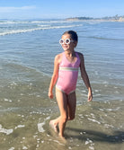 Kids Pink Sands Mabel Rainbow Embroidered One Piece – soft pink swimsuit with gold embroidery inspired by Solange Ferrarini’s colorful designs.