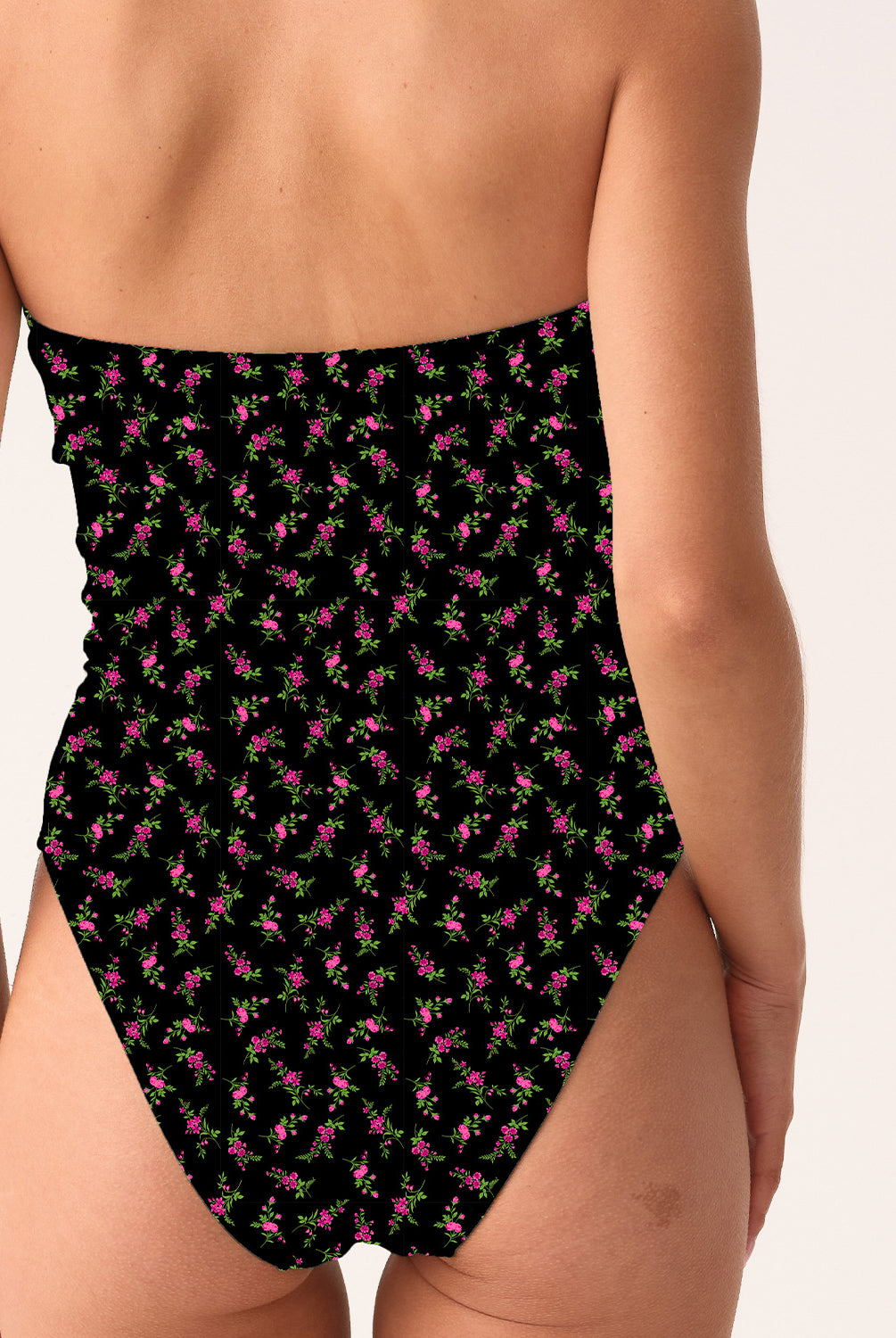 Woman wearing a black patterned strapless swimsuit on a white background