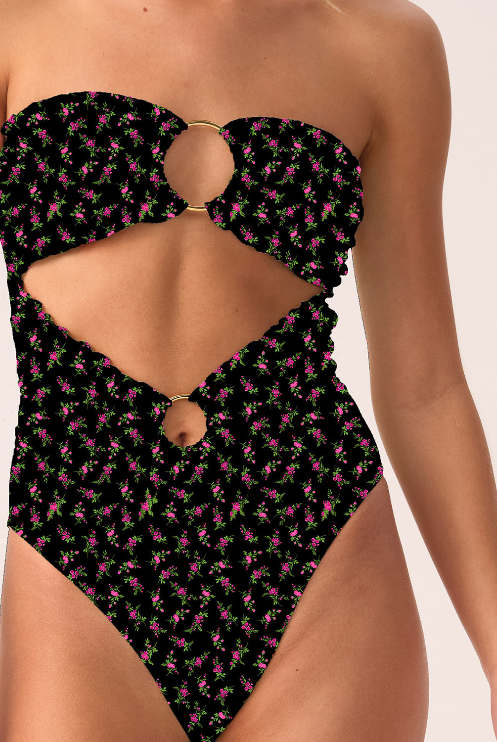 Woman wearing a black patterned strapless swimsuit on a white background