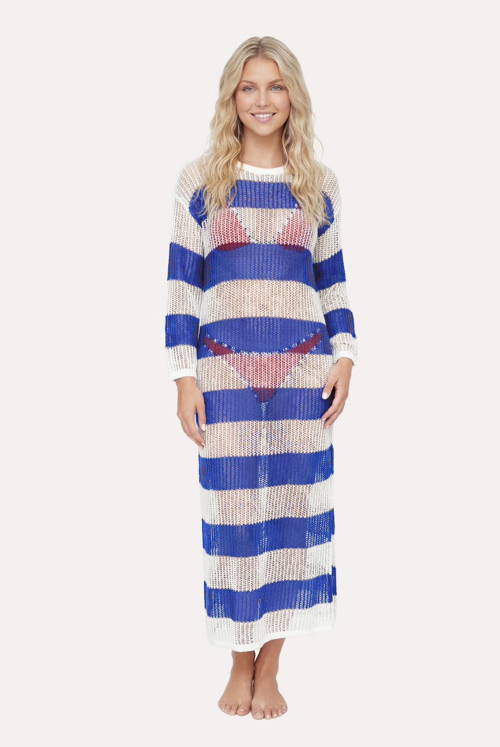 Woman wearing a long, striped dress with blue and white stripes on a plain background