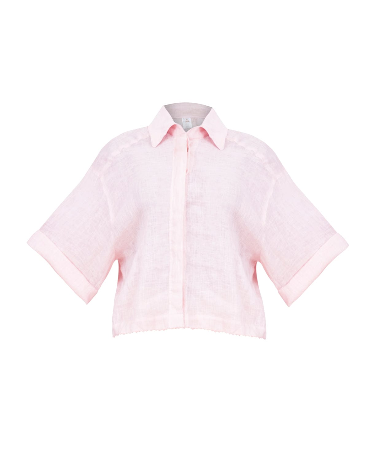 A pink linen button coverup shirt. Featured against a white wall background.