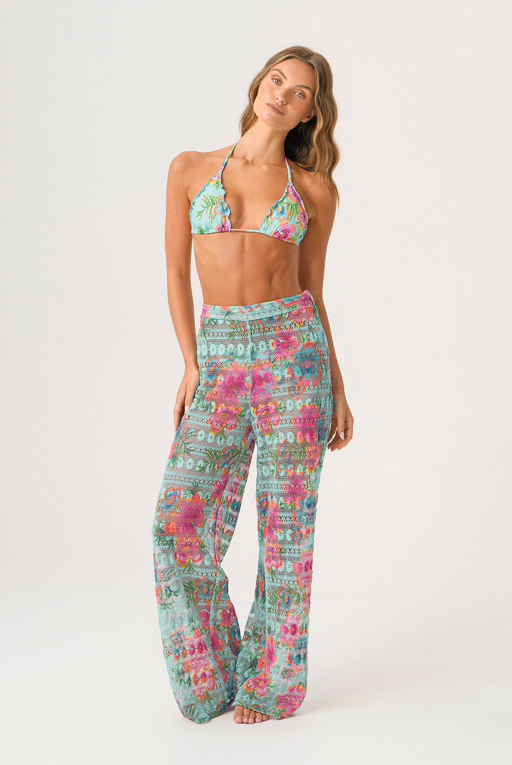 Woman wearing a floral two-piece set on a white background