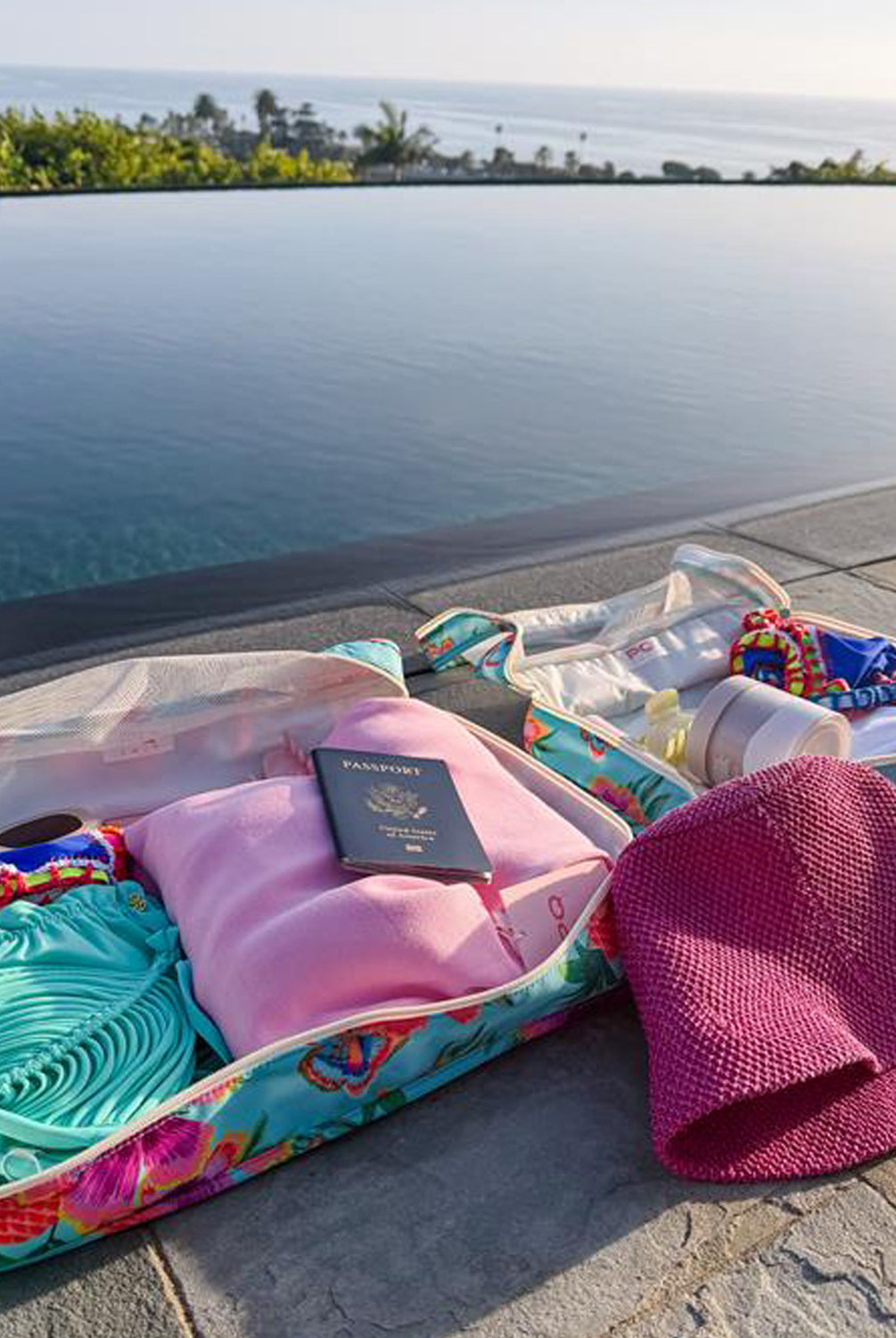 Open packing cube with beach items by a poolside
