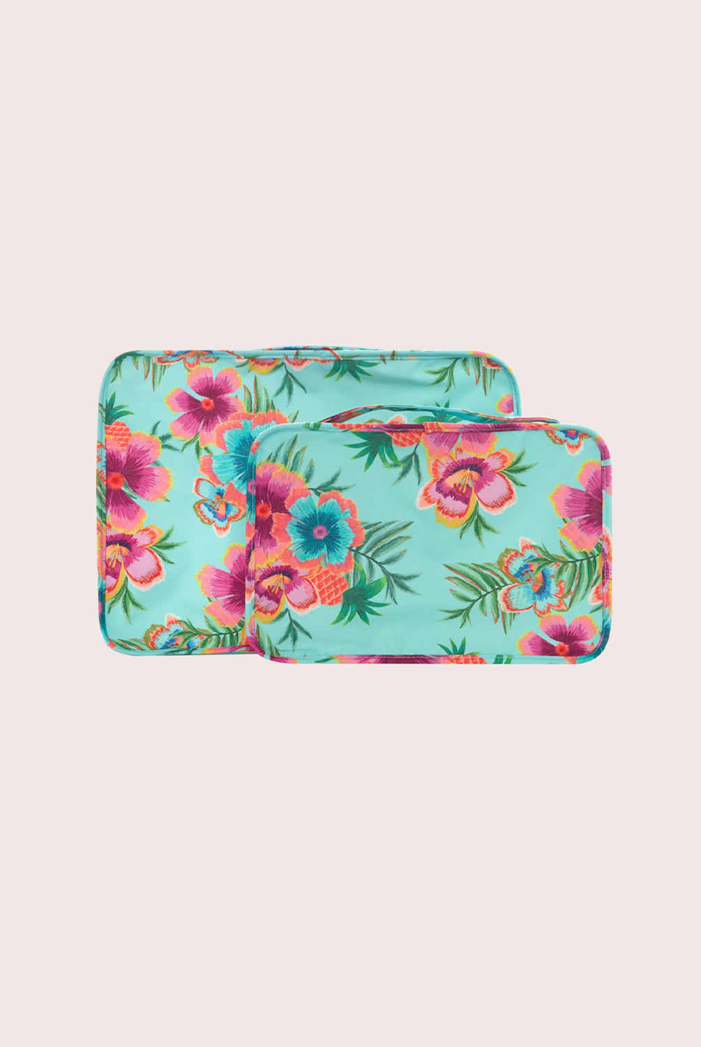 Two floral-patterned packing cubes on a light pink background