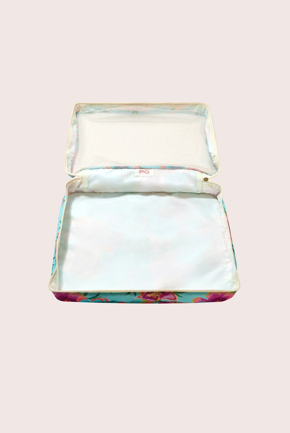 Packing cube with floral design on a light pink background