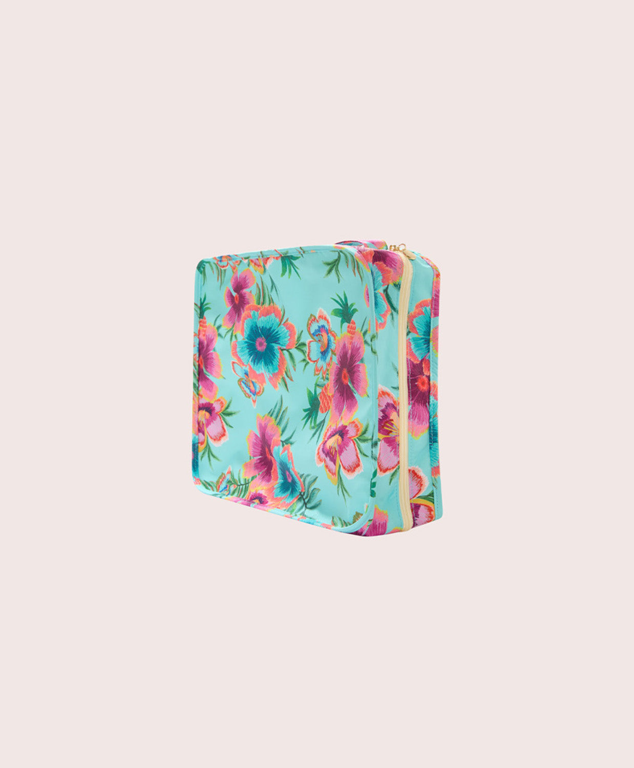 Floral-patterned packing cube on a light beige background