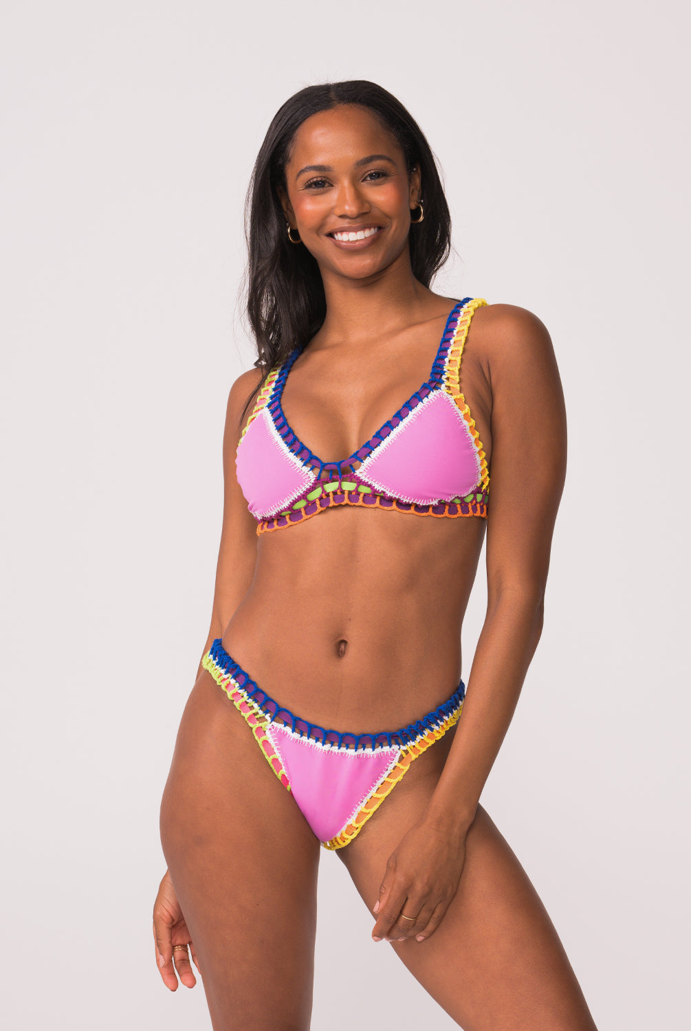 Woman wearing a colorful bikini with a white background