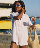 White linen romper with a collared neckline and front buttons