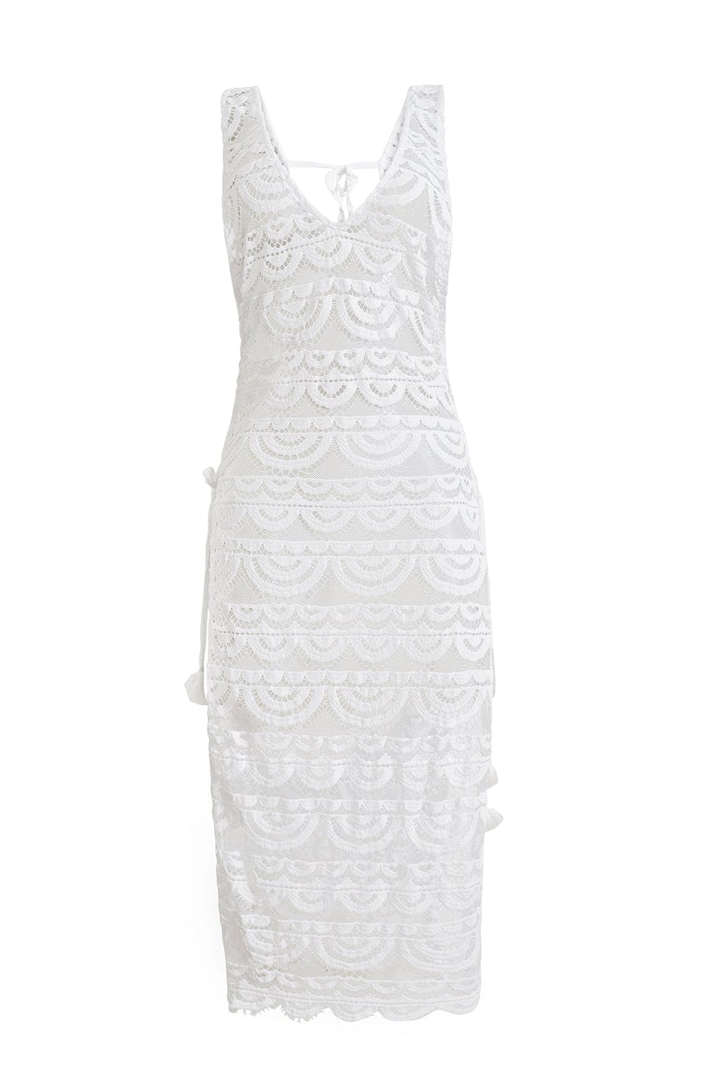 A white lace cover up dress against a white wall.
