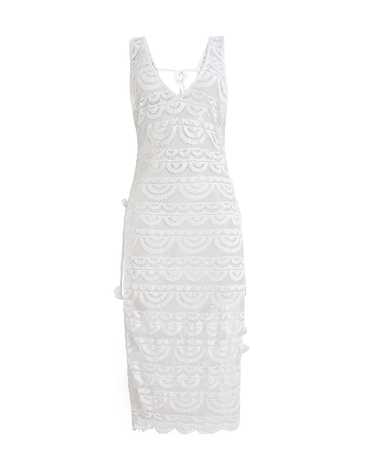 A white lace cover up dress against a white wall.