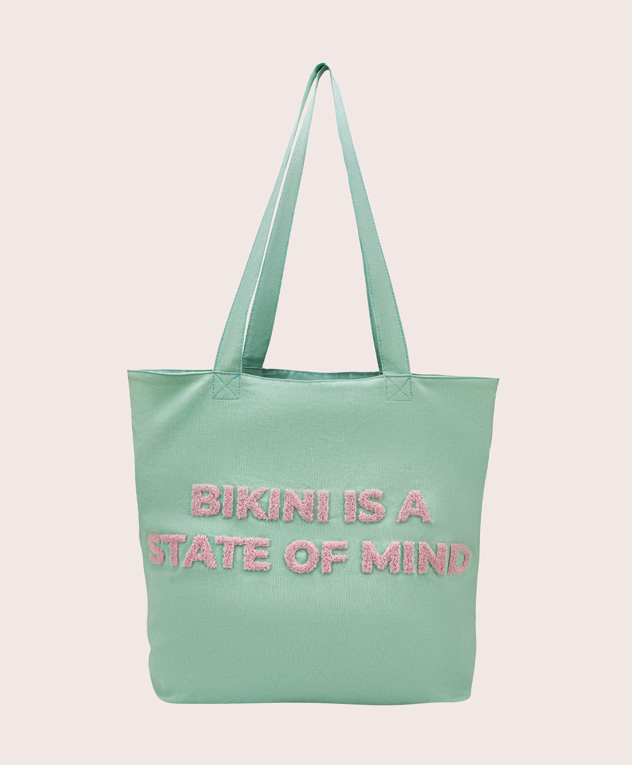 Light blue tote bag with 'Bikini is a State of Mind' text on a pink background