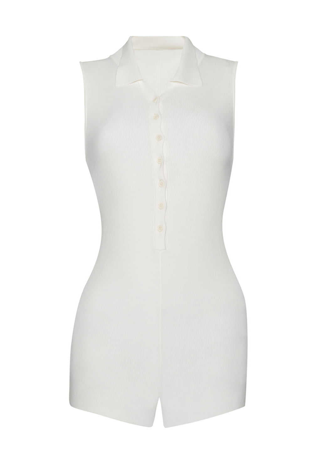 A white romper with buttons down the front against a white wall.