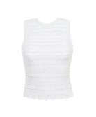A white crochet top against a white wall.