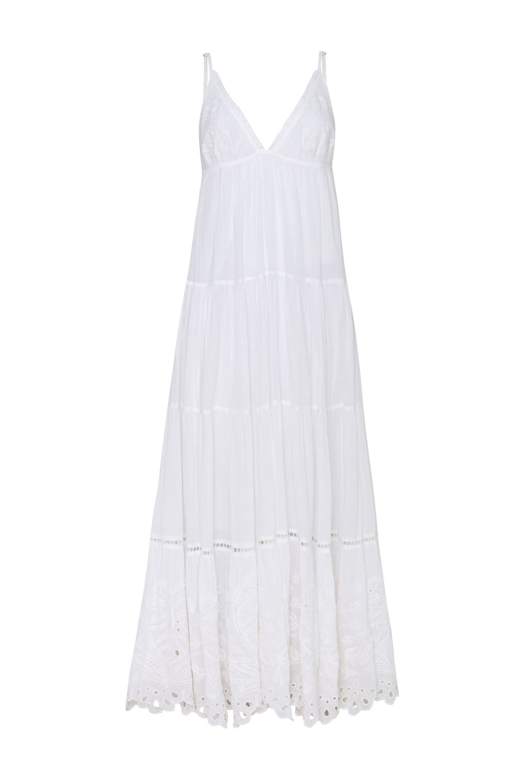 A long white dress with detailed embroidery against a white wall.