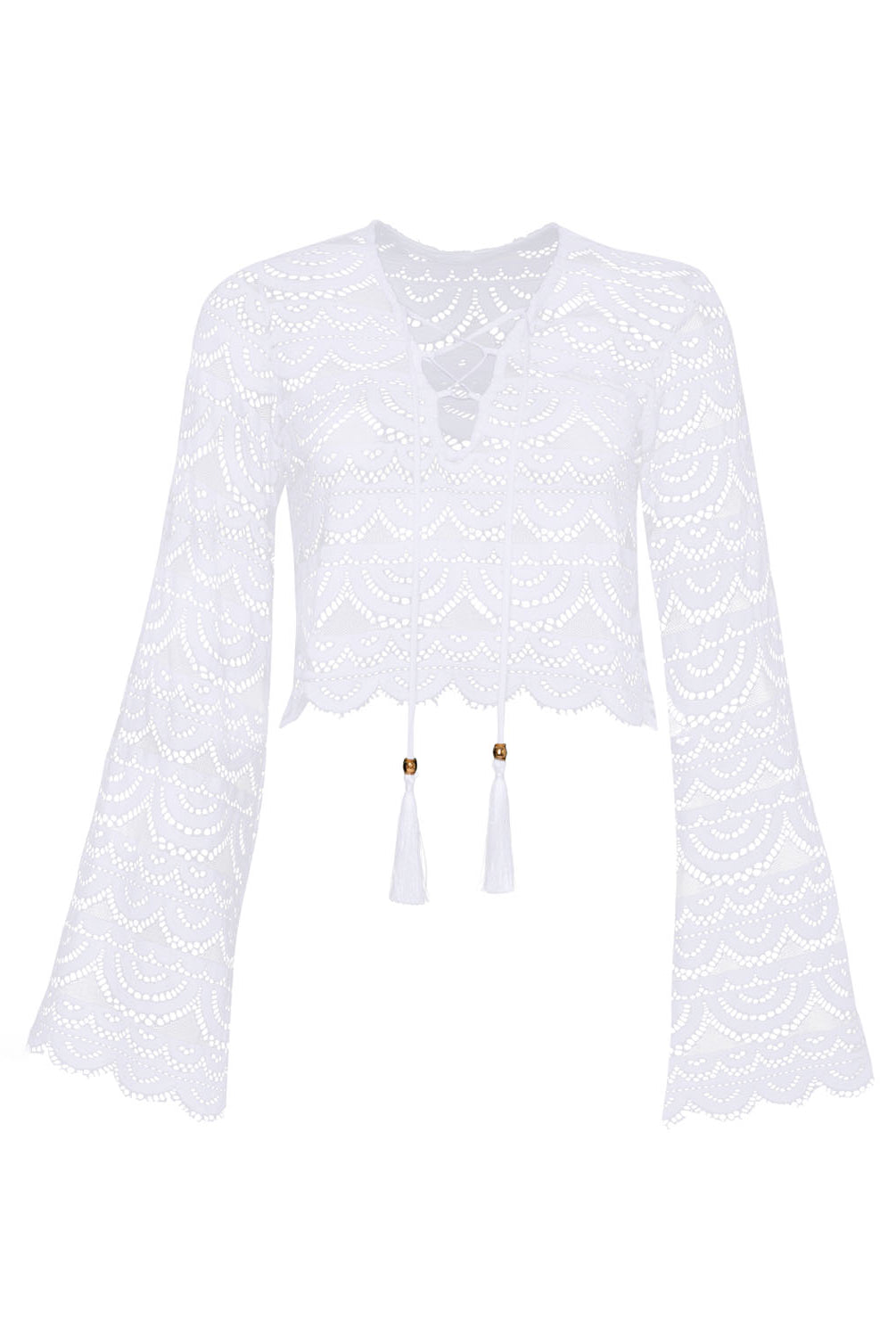 A long sleeve white lace top against a white wall.