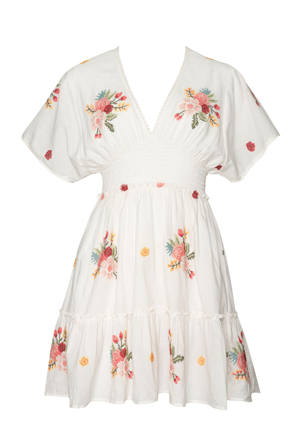 A short sleeve dress with floral details against a white wall.