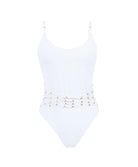 A white one piece with gold beads against a white wall.