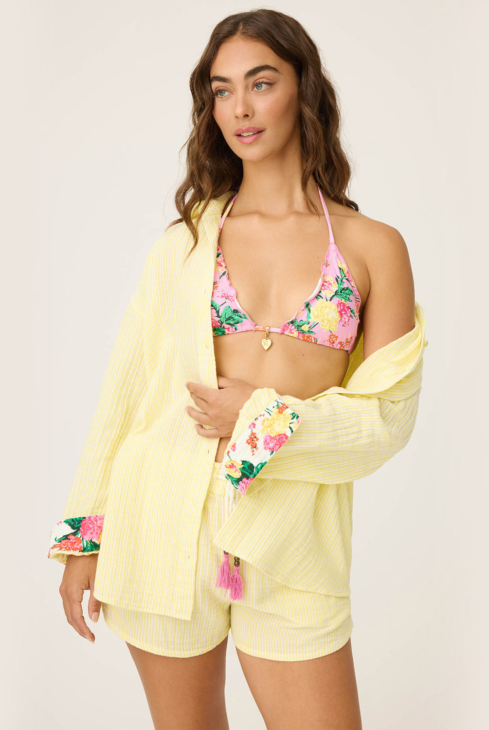 Yellow Gauze Long Sleeve with subtle yellow and white stripes, rolled-up sleeves revealing tropical floral print, button-up front and crisp collar.