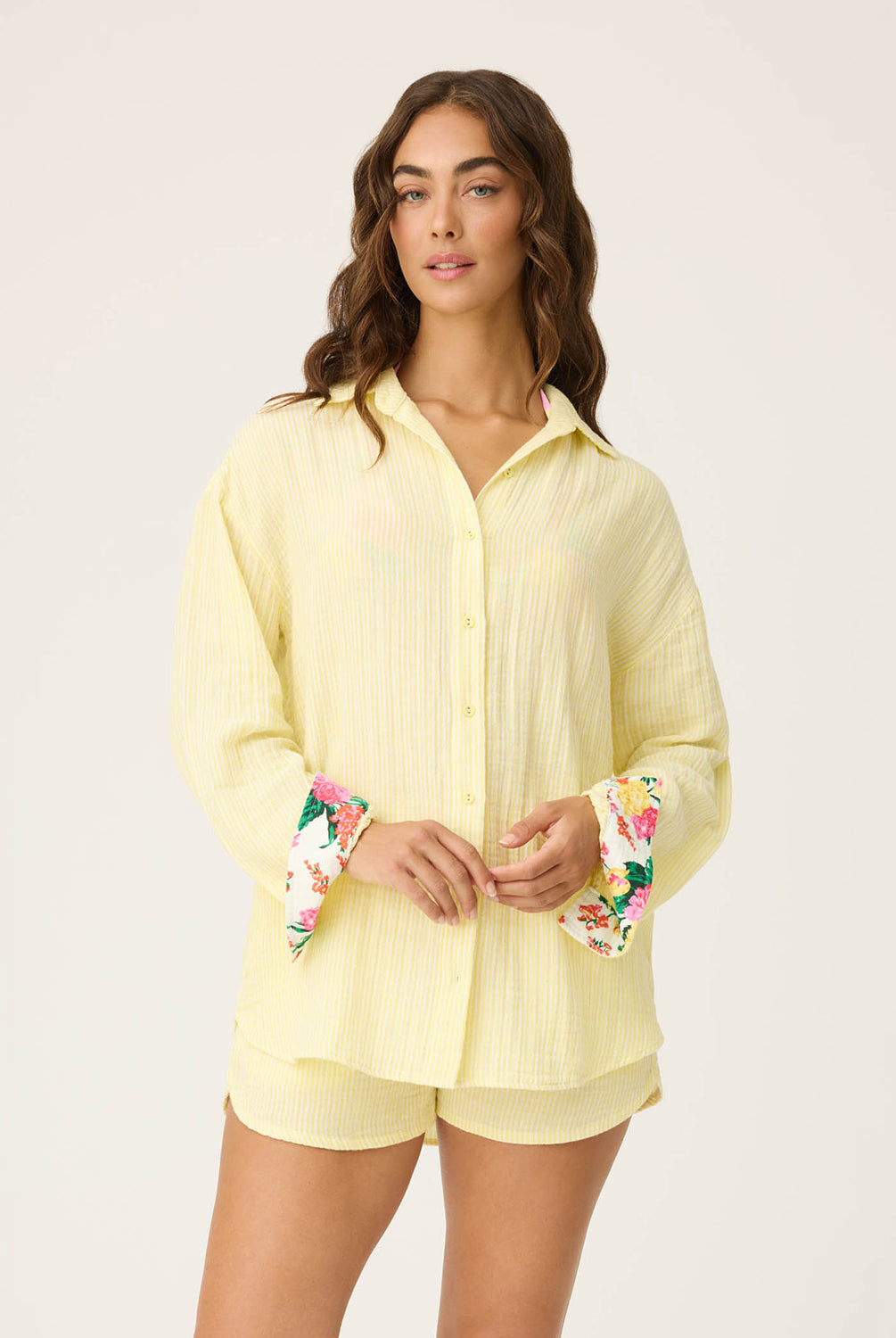 Yellow Gauze Long Sleeve with subtle yellow and white stripes, rolled-up sleeves revealing tropical floral print, button-up front and crisp collar.