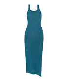 A teal dress against a white wall.