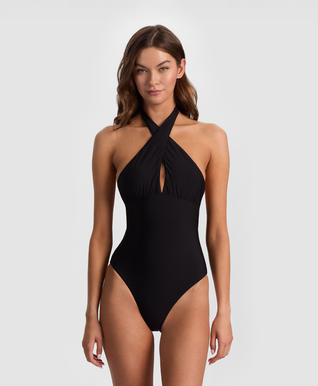 Black Cross Front One Piece from ALICE + OLIVIA x PQ Swim featuring a halter neckline, front peek-a-boo slit, and oversized bow back detail.