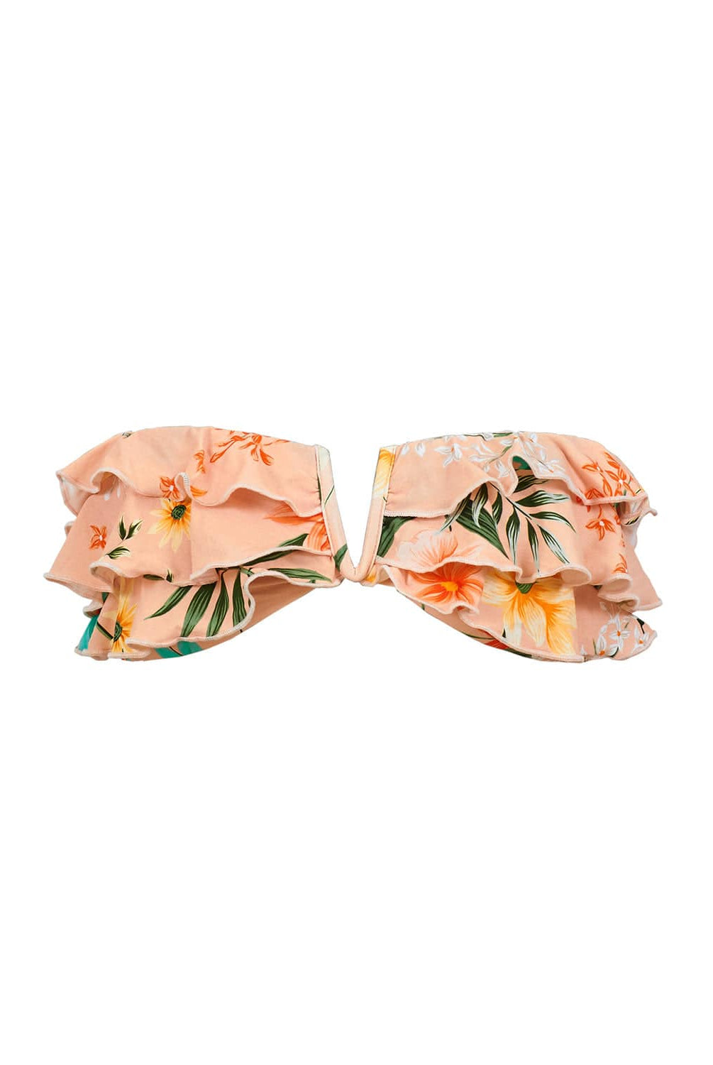 A bikini top with tropical print against a white wall.
