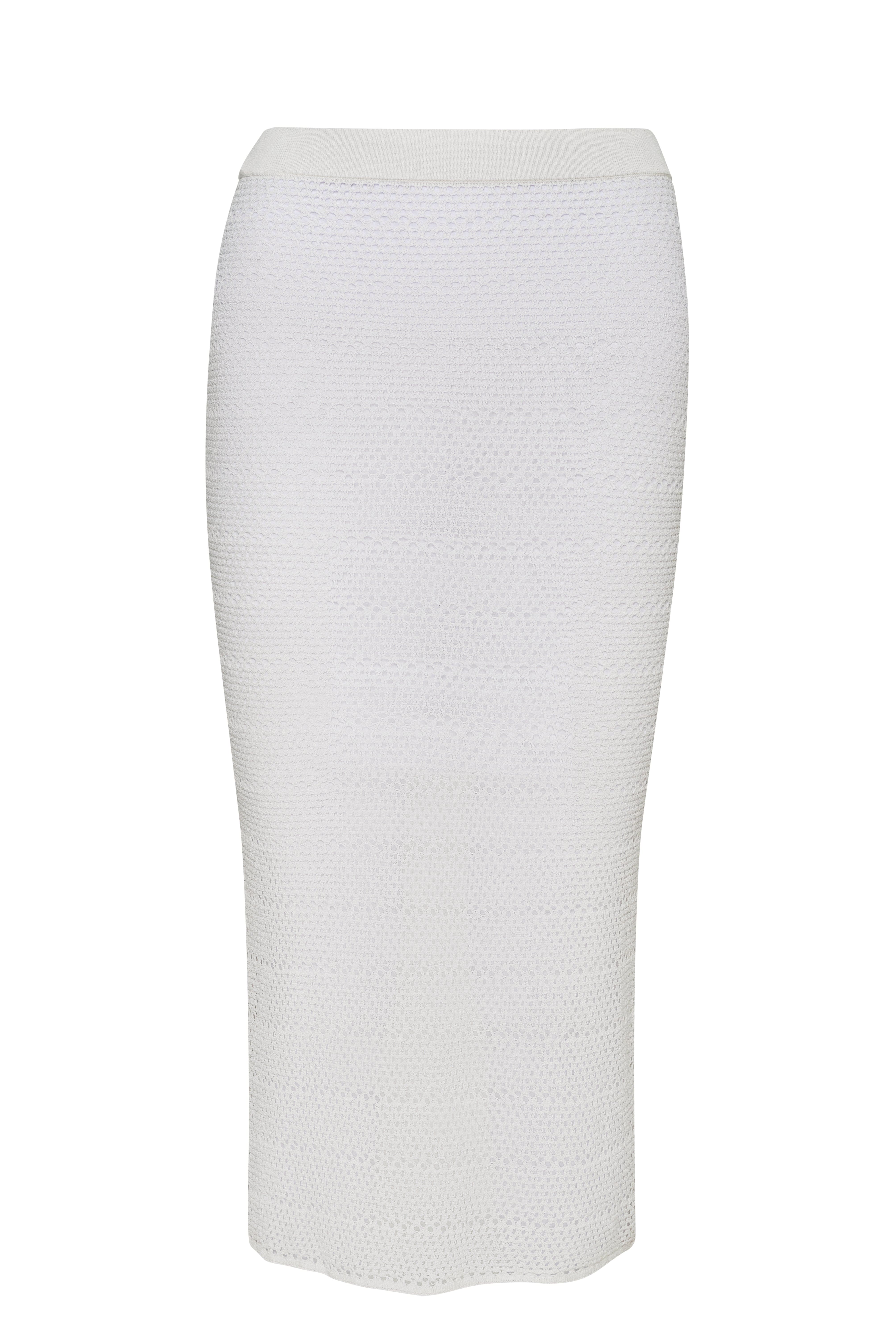 Long, white, knit skirt in front of a white background.
