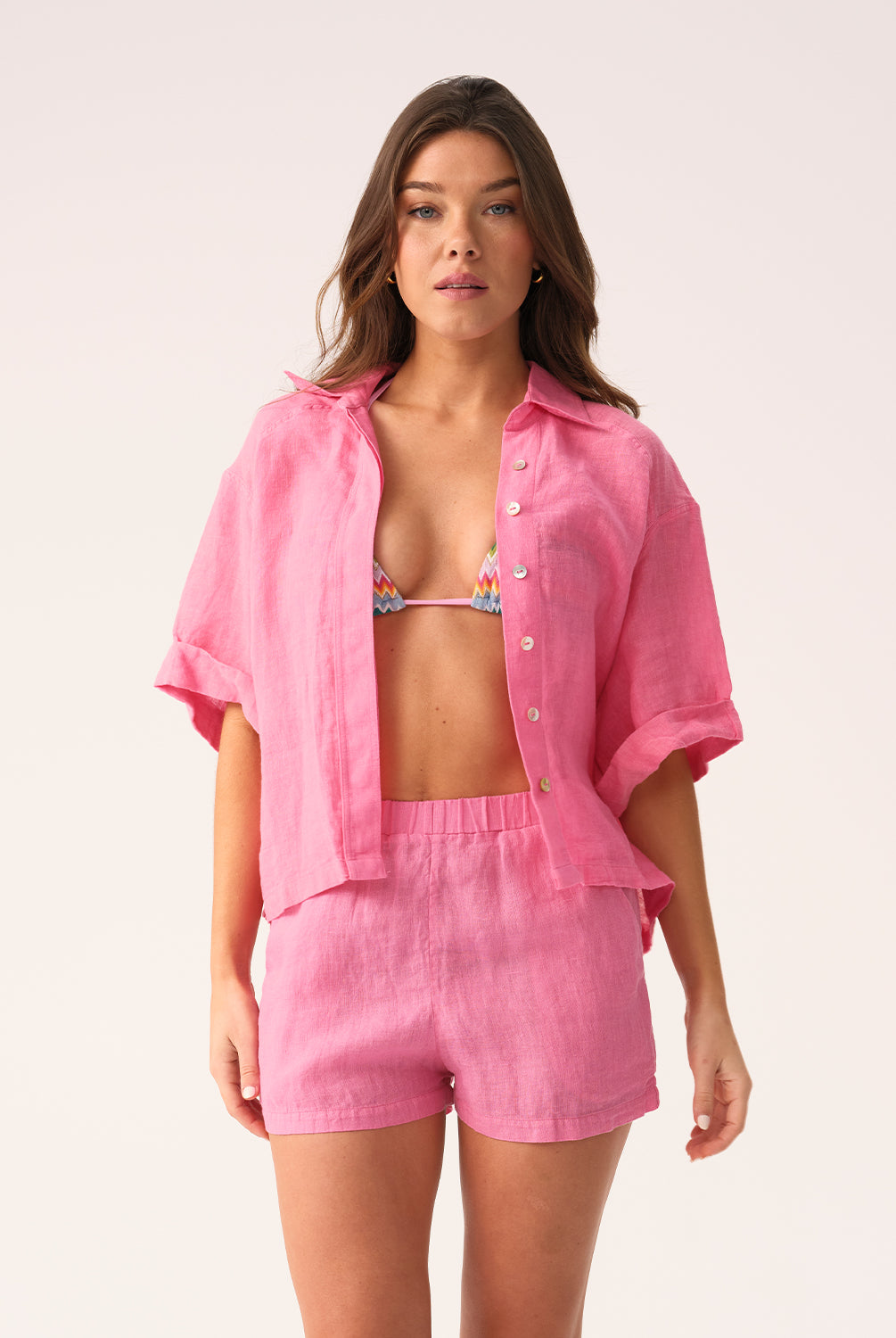 Hot pink linen shorts with a relaxed fit and flattering silhouette, designed for comfort and warm-weather style.