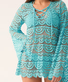 A close-up of a blue lace cover-up with long, bell sleeves and a lace-up v-neck.