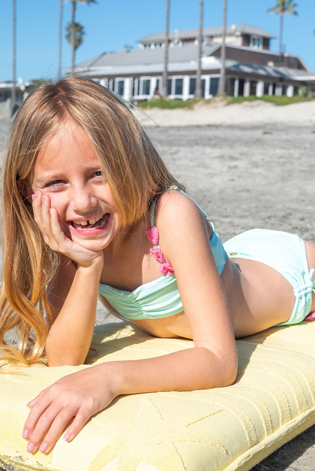 Kids Aqua Hearts Bikini with pink heart embroidery and adjustable tie straps, a playful aqua two-piece for sunny days.