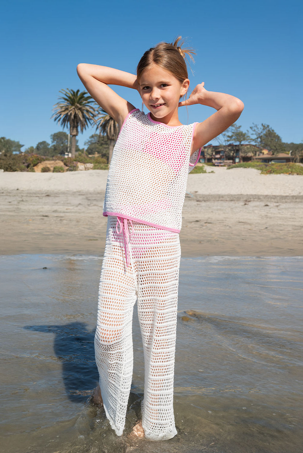 Kids White Chloe Set – a playful white crochet outfit with pink accents and a drawstring waist, perfect for sunny adventures.