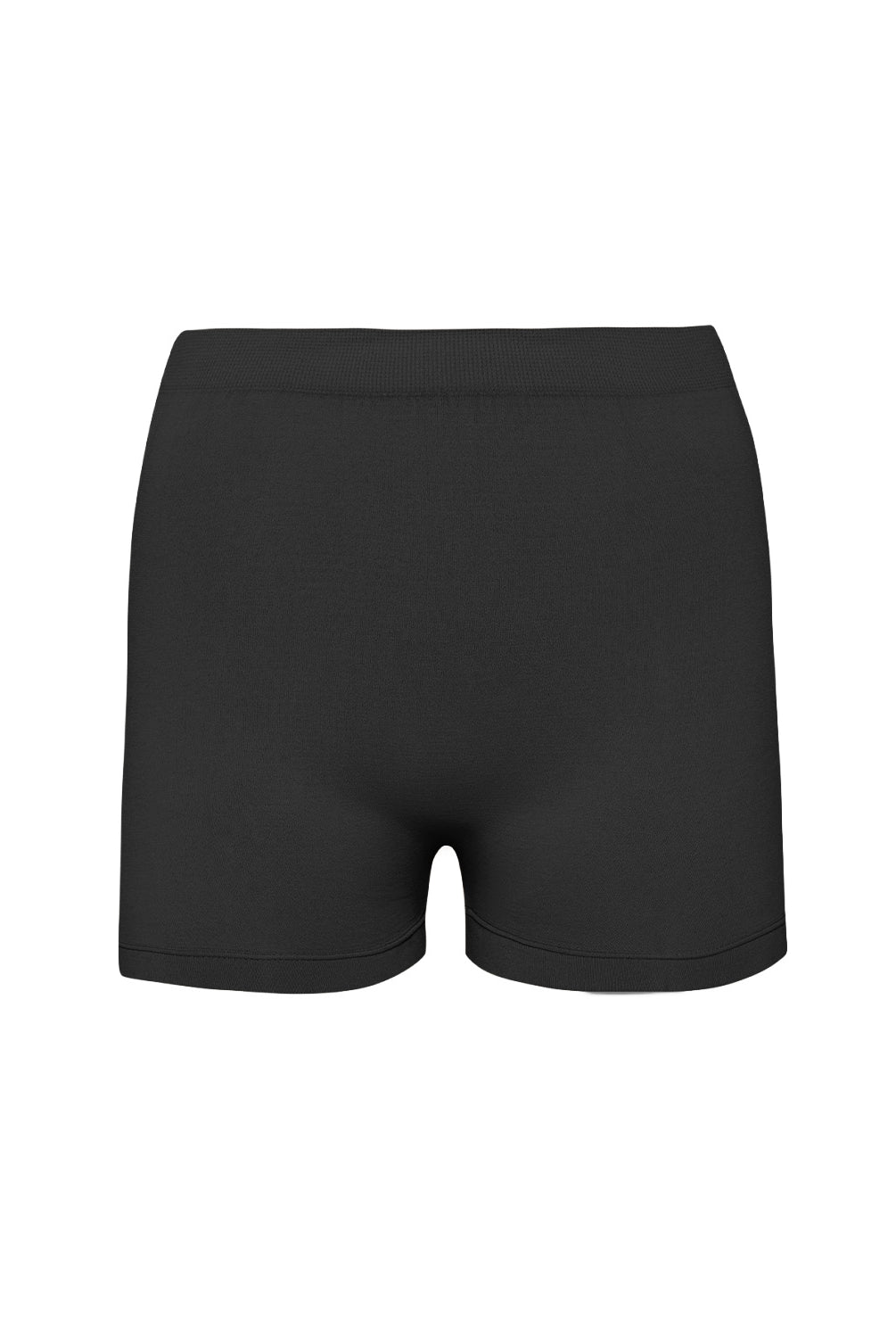 A woman wearing a black luxe layers midnight shorts standing against a white wall.