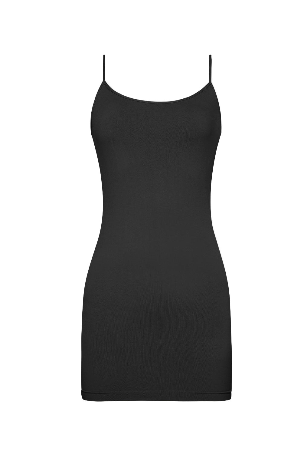 A woman wearing a short luxe layers midnight slip dress standing against a white wall.