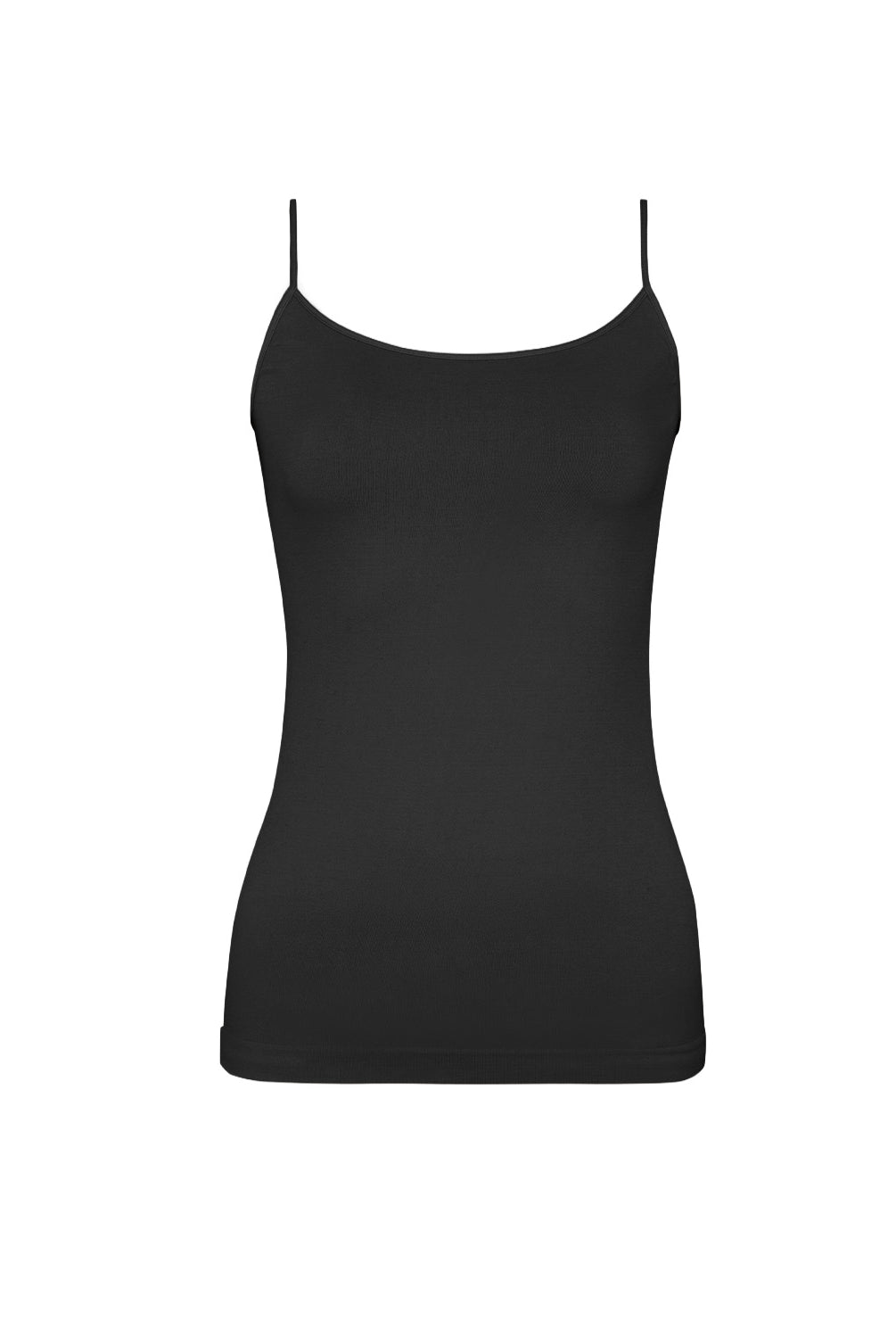 A woman wearing a black tank top and matching shorts standing against a white wall.