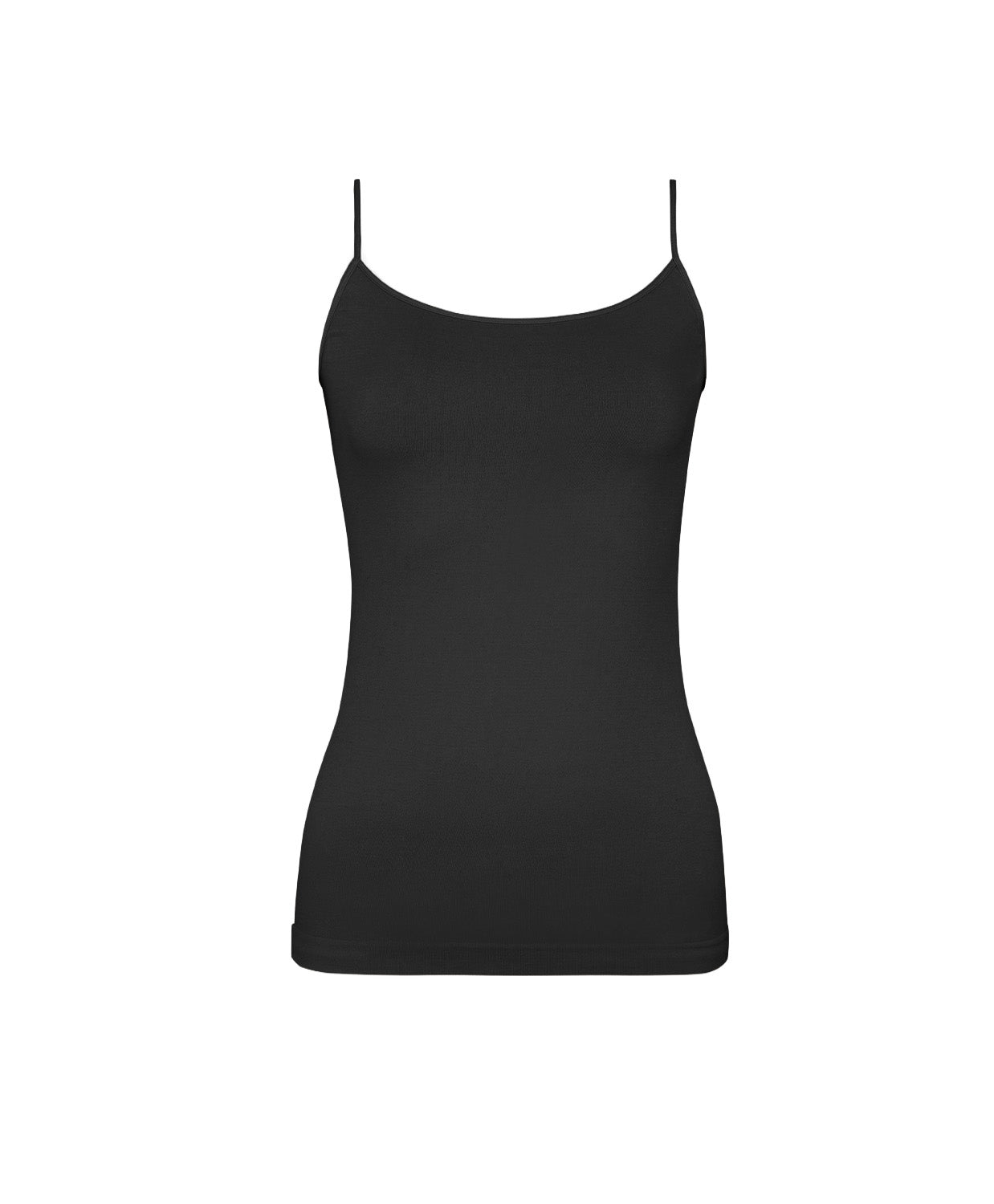 A woman wearing a black tank top and matching shorts standing against a white wall.