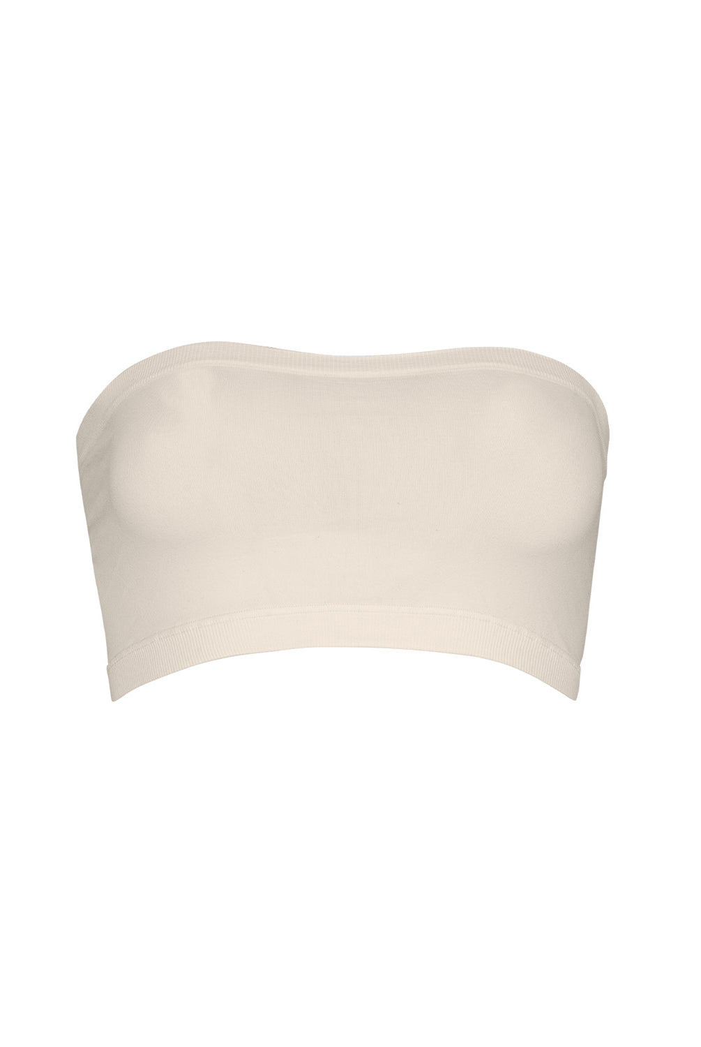 A woman wearing a nude bandeau and matching shorts standing against a white wall.