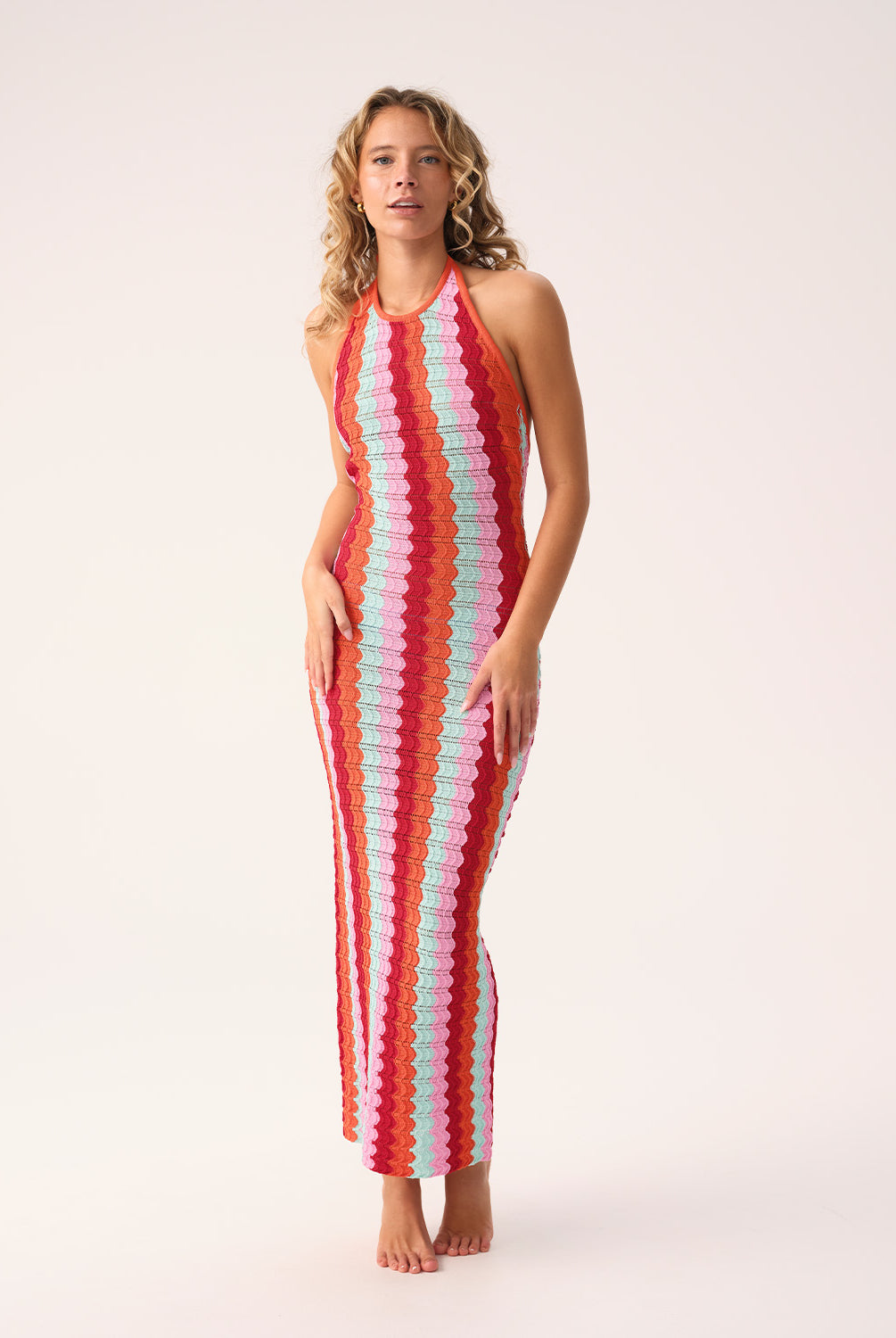Floor-length multicolor crochet dress with a low back and halter neck ties, called the Milos Aurelia Dress.