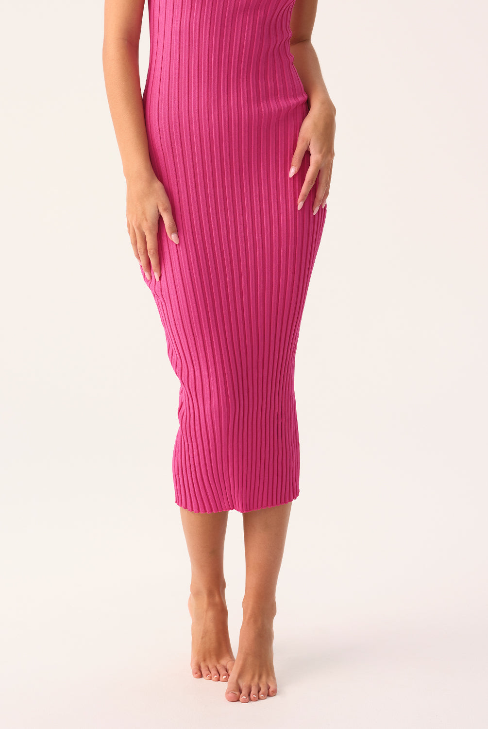 Petunia Poppy Dress in soft ribbed knit, fitted silhouette with subtle back slit, shown in pink.