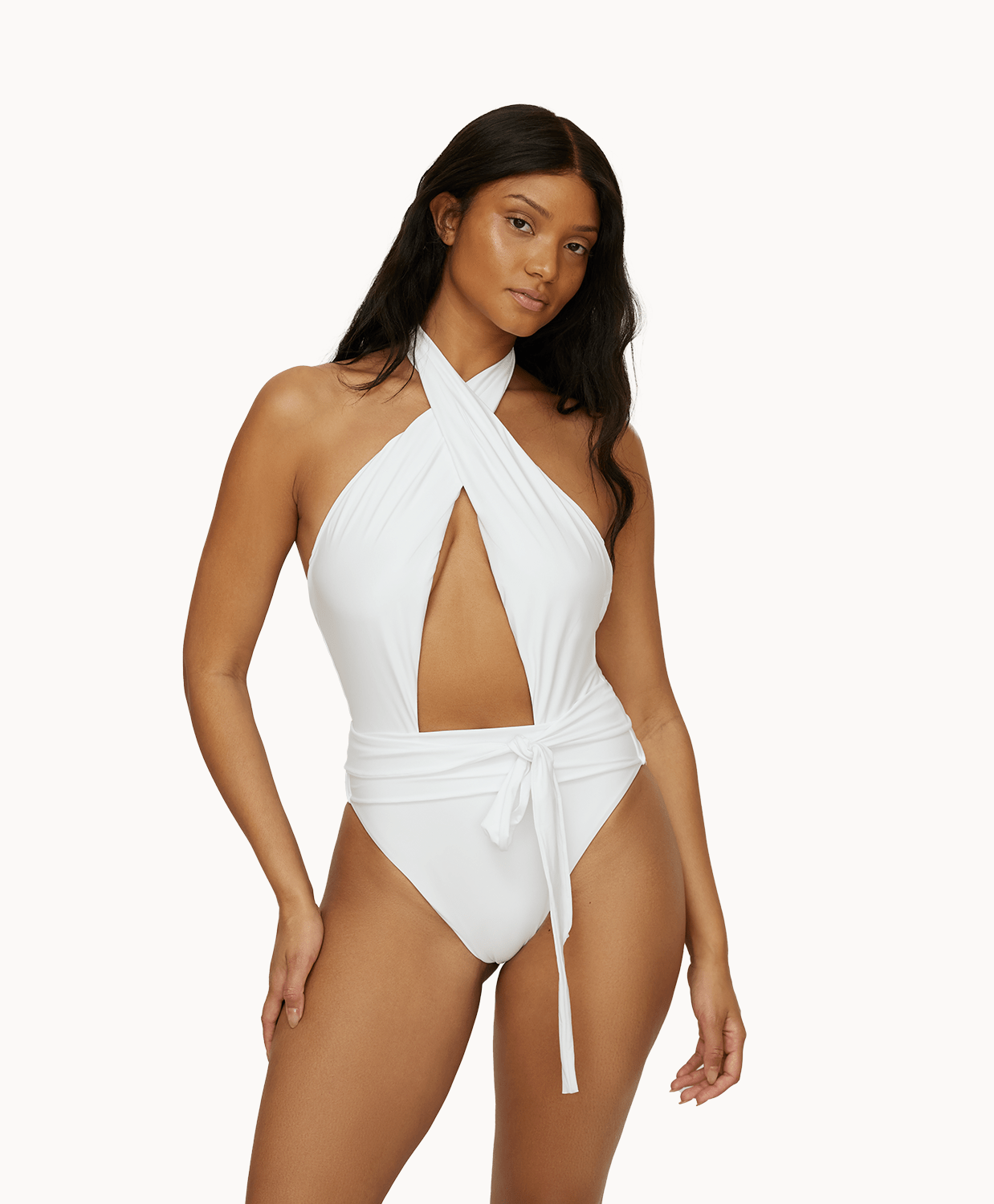 Woman wearing a white one piece in front of a white background.