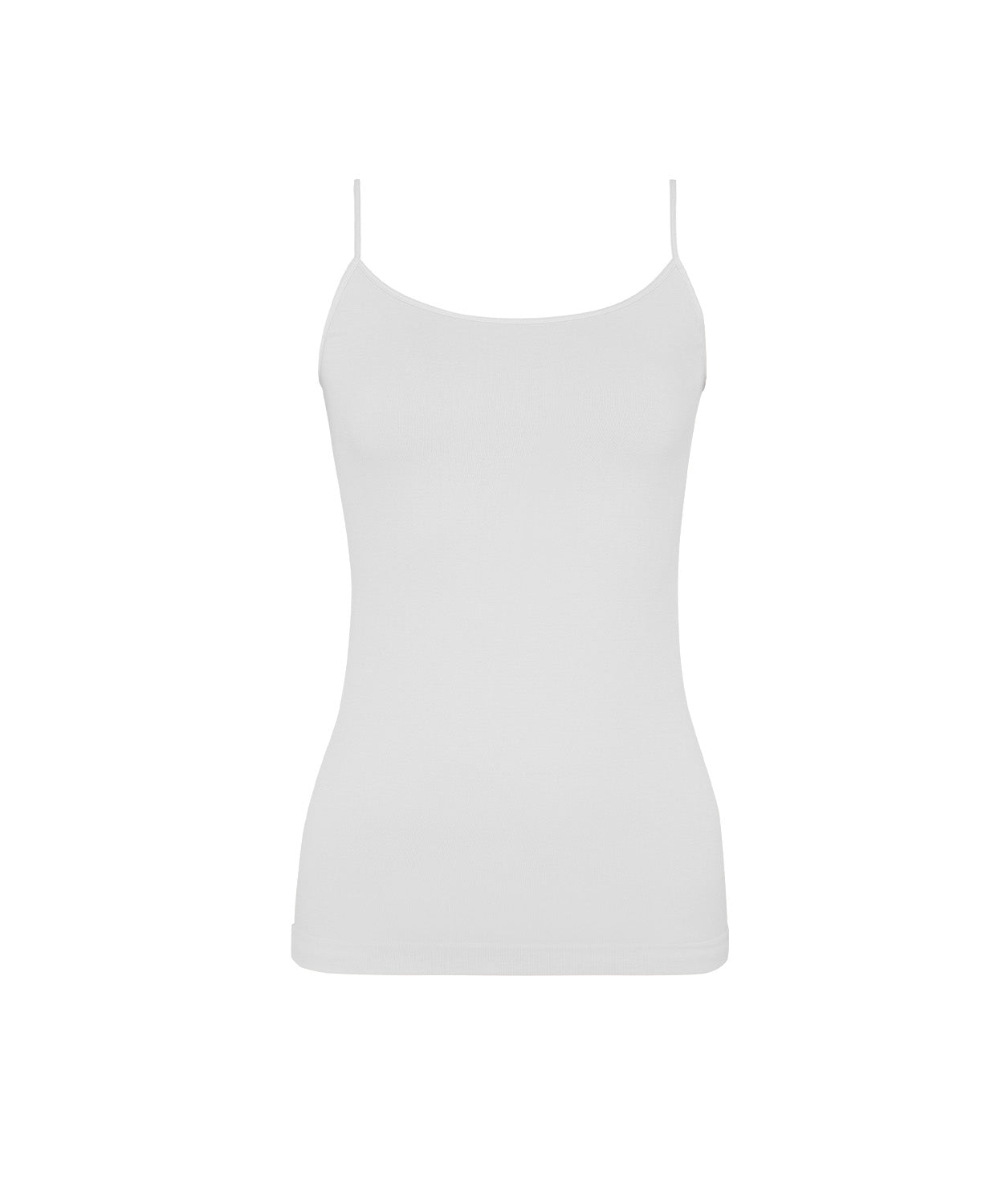 A woman wearing a white tank top and matching shorts standing in front of a white wall.