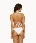 Back view of woman wearing white bikini bottom with "Just Married" embroidered in front of a white background.