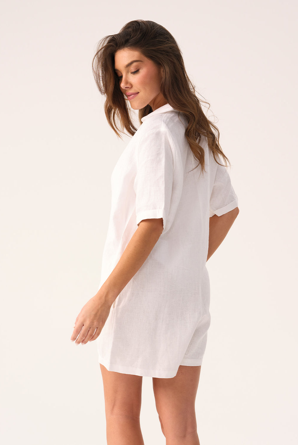 White linen romper with a collared neckline and front buttons