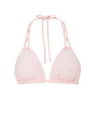 A light pink triangle bikini top with a white checkered material against a white wall.