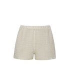 Ivory shorts with intricate details against a white wall. 