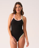 Woman wearing a black swimsuit with colorful straps on a white background