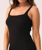 Black dress worn by a woman on a white background