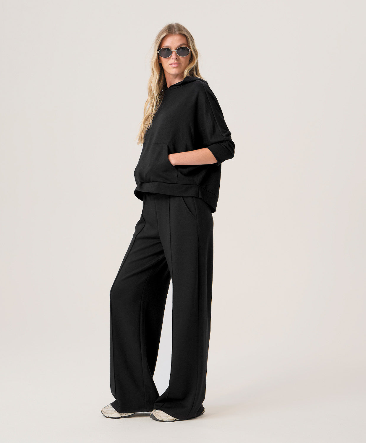 Woman wearing a black outfit on a white background