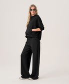 Woman wearing a black outfit on a white background